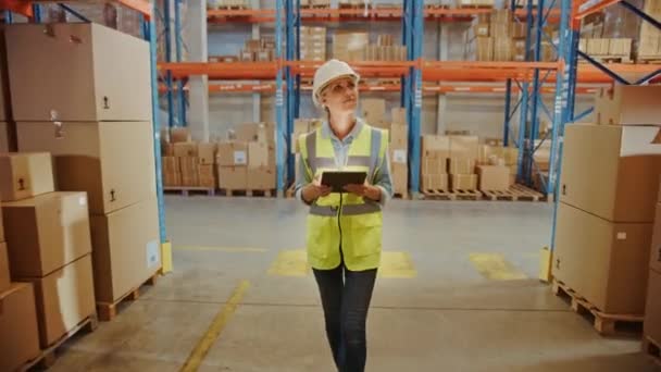 Big Warehouse Female Worker uses Digital Tablet Walking — Wideo stockowe