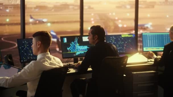 El equipo de control de tráfico aéreo trabaja en la torre del aeropuerto al atardecer — Vídeos de Stock