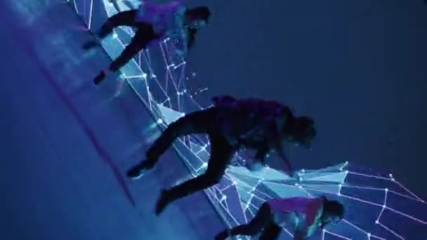 Three Dancers Performing in Front of Animated Digital Screen — Stock Video