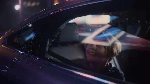 Young Boy in Car in City at Night — Stock Video