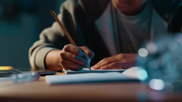 Chica joven haciendo tareas en el cuaderno en casa — Vídeo de stock