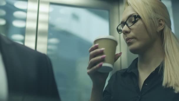 Drinking Coffee in Office Elevator — Stock Video