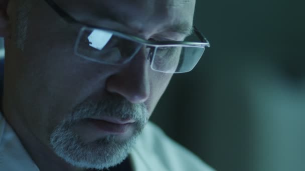 Portrait of Middle Aged Male using Tablet and Have Reflections of Screen in Glasses. Close-up. — Stock Video