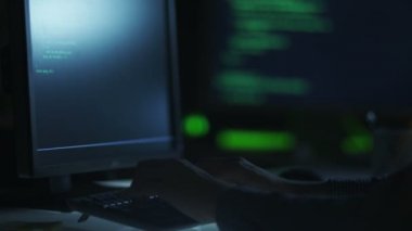 Hacker is Working at Night. Quickly Typing Commands in Terminal.