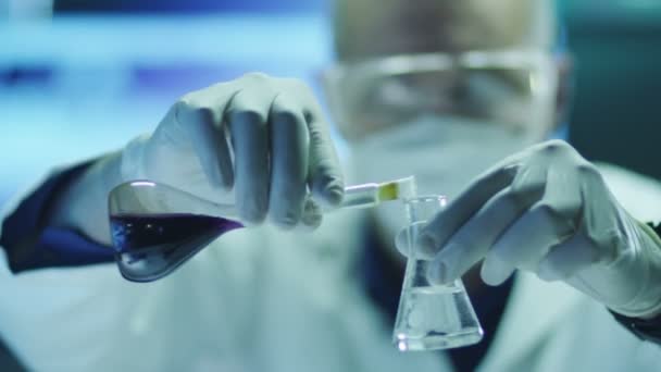 Scientist in Safety Glasses is Mixing Reagents in Test Tube. — Stock Video