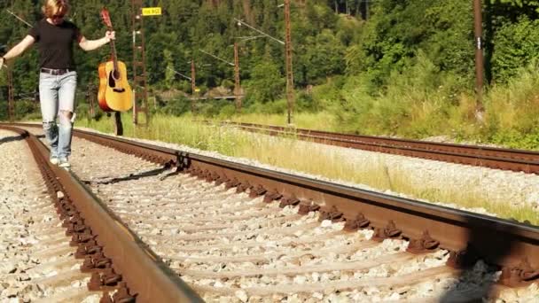 Teenager balancing on the railways — Stock Video