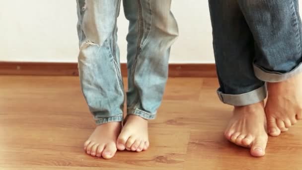Mother and son stepping on foot each other — Stock Video