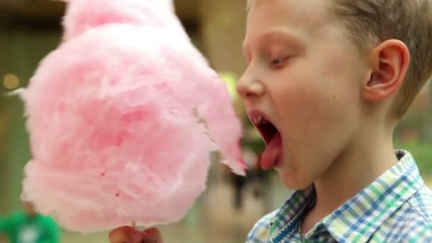 Boy consuming cotton candy — Stock Video