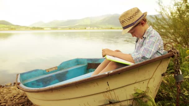 Boy reading book — Stock Video