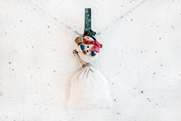 Christmas snowman clothespin holding sack — Stock Photo, Image