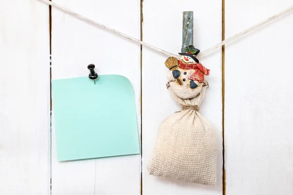 圣诞雪人夹子拿着麻袋，固定的便条纸 — 图库照片