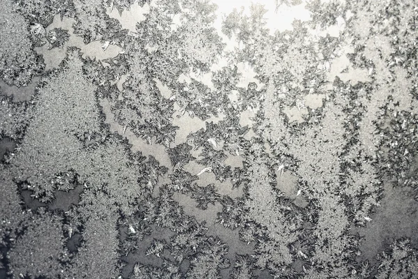 Snowflakes and ice on frozen window — Stock Photo, Image