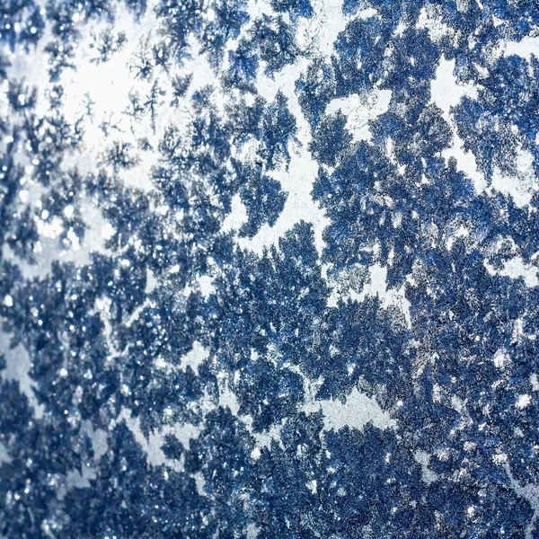 Snowflakes and ice on frozen window — Stock Photo, Image