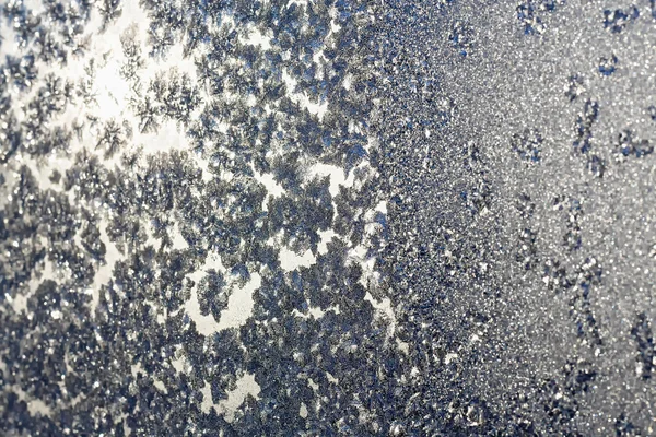 Snowflakes and ice on frozen window — Stock Photo, Image