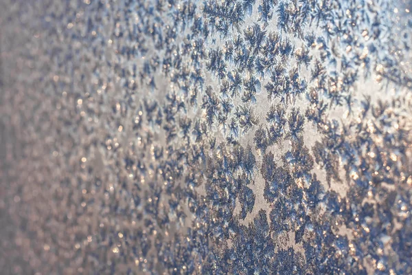 Frost and snowflakes on frozen window — Stock Photo, Image