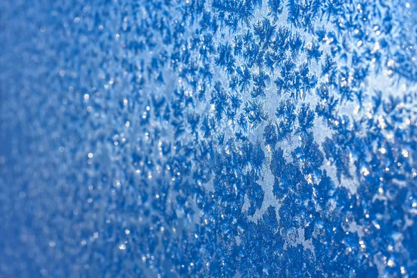 Snowflakes and ice on frozen window — Stock Photo, Image