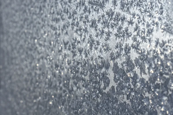 Snowflakes and ice on frozen window — Stock Photo, Image