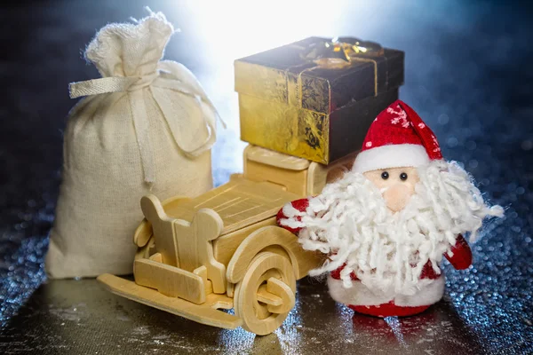 Santa Claus with wooden car, gift box and sack — Stock Photo, Image