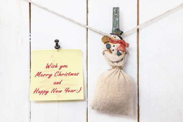 Snowman clothespin holding sack and Christmas greeting note