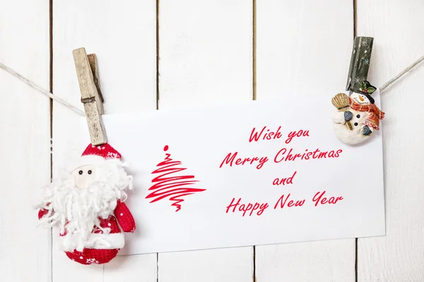 Santa Claus and snowman clothespin holding Christmas greeting ca — Stock Photo, Image