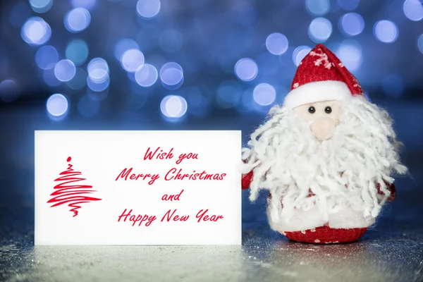 Santa Claus with Christmas greeting card — Stock Photo, Image