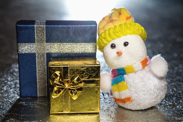 Christmas snowman toy with gift boxes or presents — Stock Photo, Image