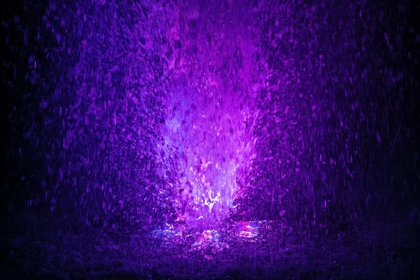 Colorful fountain splashes violet and white color — Stock Photo, Image