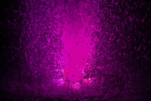 Colorful fountain splashes pink color — Stock Photo, Image