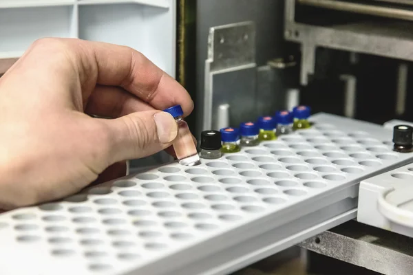 Laborant takes small bottle in laboratory — Stock Photo, Image