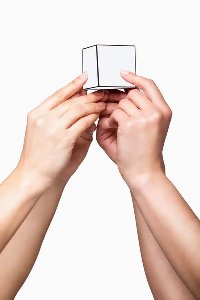 Mãos segurando cubo branco — Fotografia de Stock