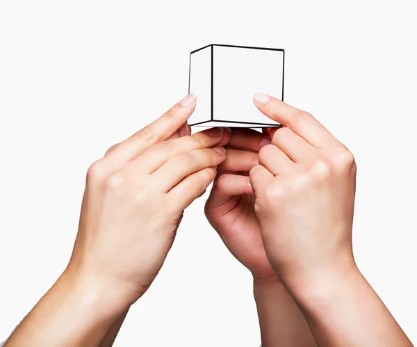 Mani che tengono il cubo bianco — Foto Stock