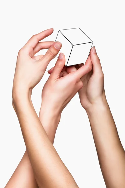 Mãos segurando cubo branco — Fotografia de Stock