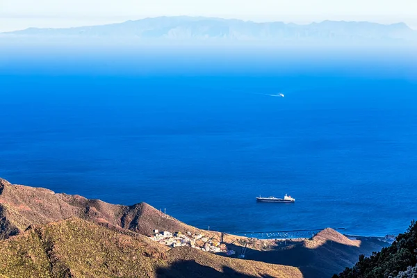 View from above on ocean and island on background