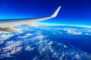 Uçak kanadı yukarıda gökyüzü ve bulutlar