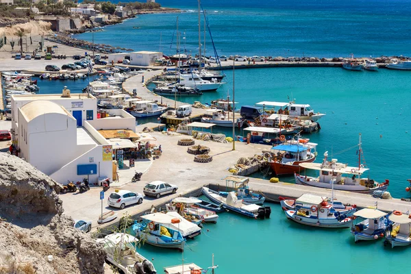 Kijk op de kleine haven en vissersboten geparkeerd in de buurt van pier van Vlychada stad op Santorini eiland, Griekenland — Stockfoto