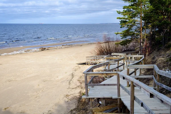Strada di legno per la spiaggia sabbiosa della città di Saulkrasti in Lettonia — Foto Stock