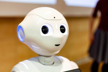 Pepper - the japanese semi humanoid robot assistant closeup on face / head, portrait . Artificial intelligence, modern human like robotics concept clipart