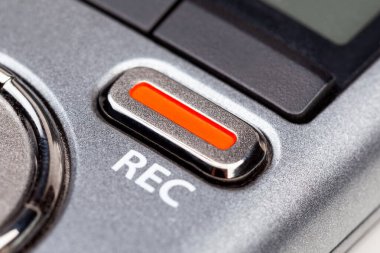 Red REC recording button on a modern pocket audio voice recorder, switch object macro extreme closeup Secretly recording, journalist or reporter equipment, simple live music recording abstract concept clipart
