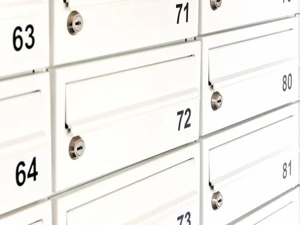 White private mailbox, letterbox detail, object closeup. Simple locked mail box, letter box up close. Modern apartment condo post message box, personal mail address, communication abstract concept