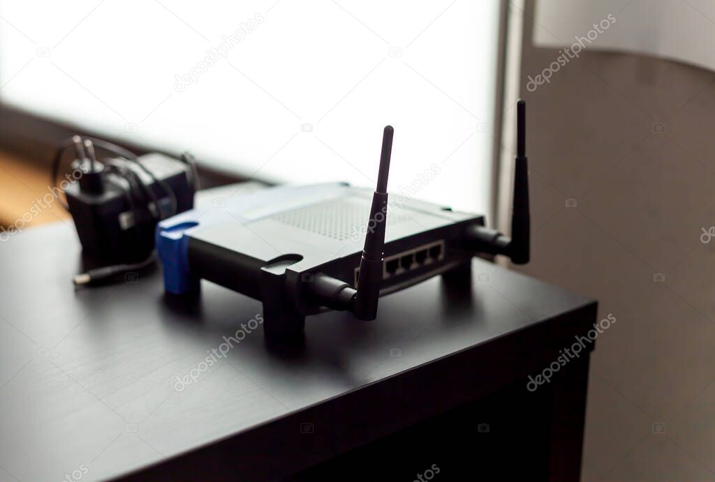 Small soho wifi access point, router at the office, shallow depth of field. Object antennas closeup, interior, nobody. Small office home office wi-fi technology, 802.11 networking abstract concept