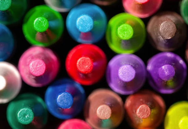 Colorful group pf wax crayons, large wax crayon set top view, macro, extreme closeup, detail. Vivid background texture, shot from above. Early school education, learning concept, simple backdrop