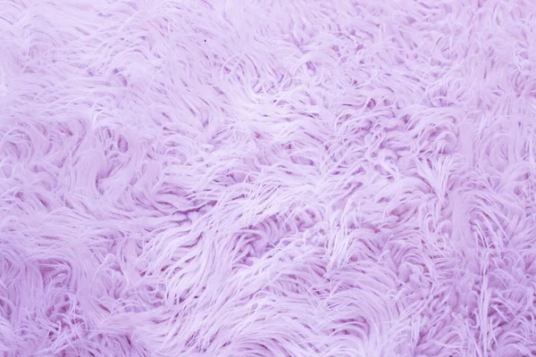 Pink fur artificial texture. Soft and delicate background for designers.