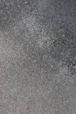 A close up view of a textured surface featuring a blend of gray tones. Subtle variations create an interesting pattern revealing depth and movement.