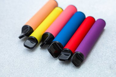Beyaz arka planda parlak bir bukle seti. Elektronik sigaralar, minimalizm. Vaping yaşam tarzı konsepti