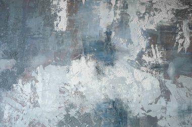 Mavi ve gri boya karışımı ile kaplı bir duvar ilginç doku ve desenleri gösterir. Yüzeydeki ışık varyasyonları vurguluyor. Bu görünüm modern bir tasarımı yakalar.