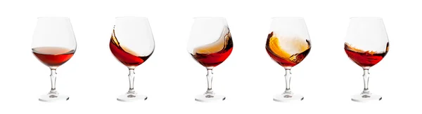 Set of brandy glasses with splashes isolated on white background — Stock Photo, Image