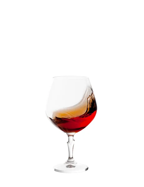 Glass with brandy and splashes isolated on white background — Stock Photo, Image