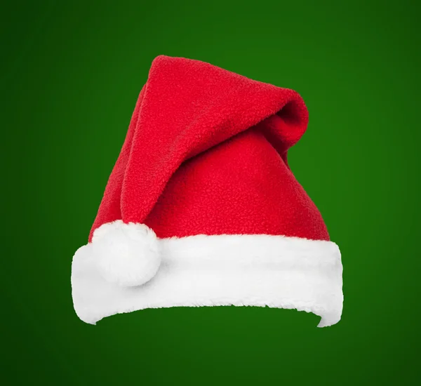 Christmas Santa red hat isolated on green background — Stock Photo, Image