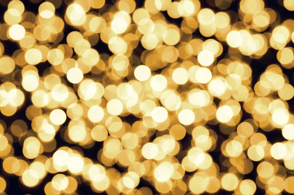 Золотисто-жёлтый обезжиренный фон рождественских огней Стоковое Изображение