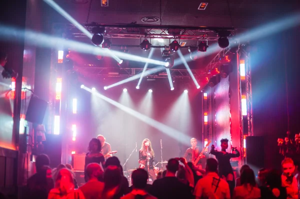 Color disco club light with laser show and dancing people — Stock Photo, Image